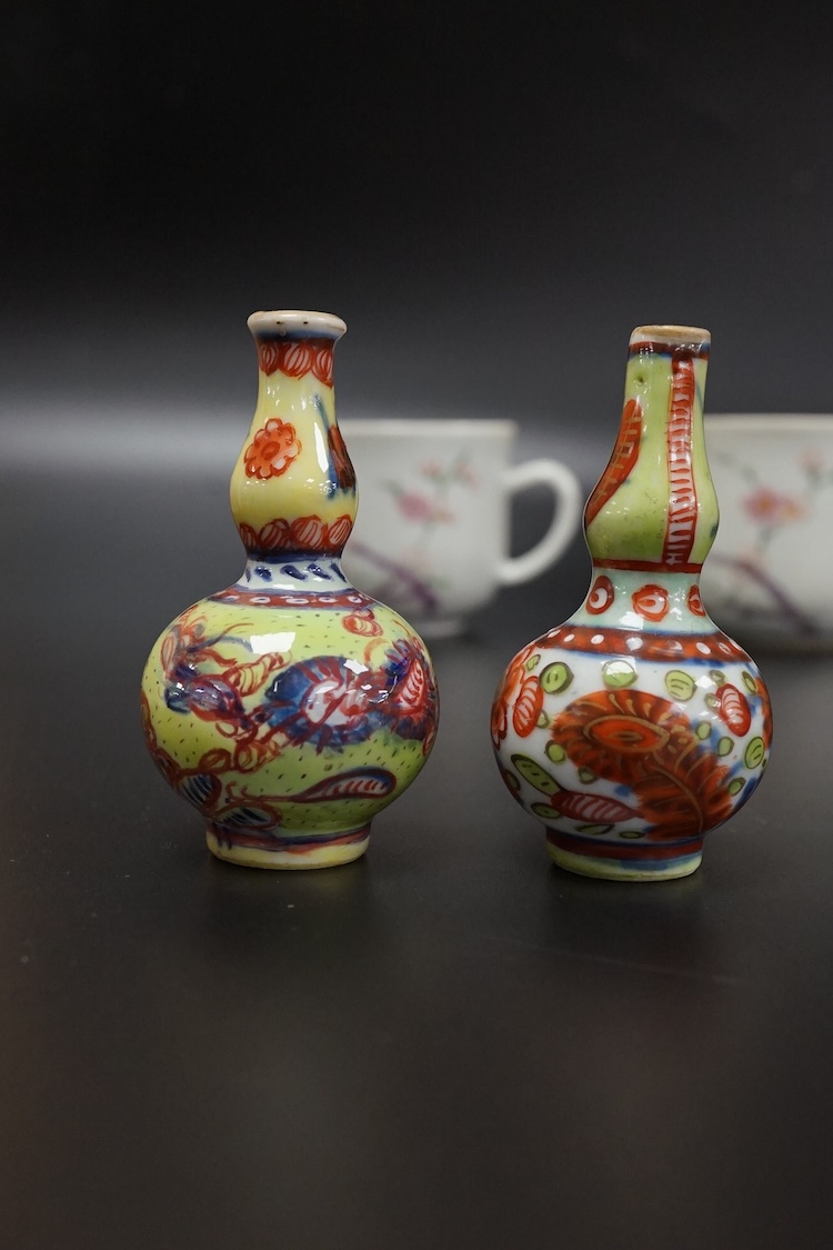 Two Chinese famille rose cups, Yongzheng period and two miniature clobbered vases, largest 6cm high
